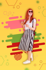 Favorite playlist. Red-haired fashionable beaming girl wearing long striped skirt listening to her favorite playlist