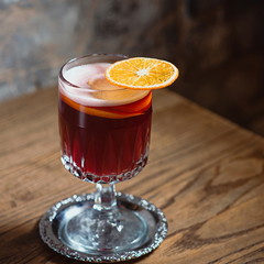 red mulled wine decorated with dryed orange on the table in the bar