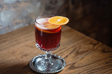 red mulled wine decorated with dryed orange on the table in the bar
