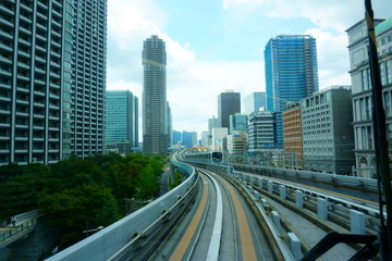 Fototapeta na wymiar Scenery of a train traveling on the elevated rail of Yurikamome Line in Tokyo
