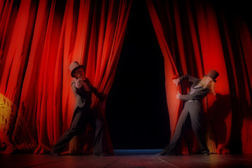 Actor and actress in tuxedos close the theater curtain © andrys lukowski