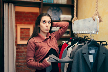 Beautiful Elegant Woman Checking out Sweaters in a Shop