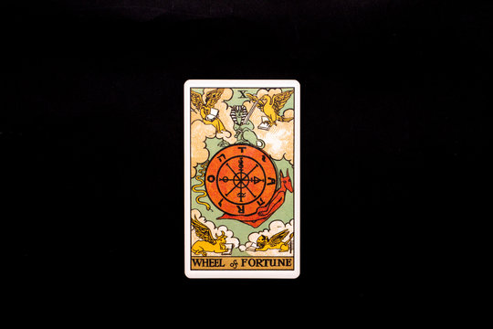An individual major arcana tarot card isolated on black background. Wheel of fortune.