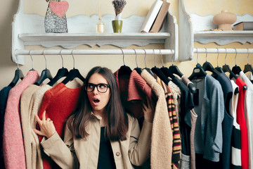 Funny Girl Between Many Sweaters on a Clothing Stander 