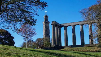 The National Monument and Nelson Monument on Calton Hill in Edinburgh on a bright autumn day.