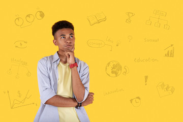 Importance of education. Appealing meditative guy staring up and touching face