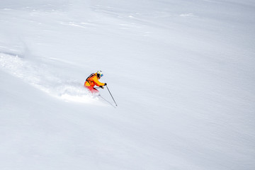 One skier skiing downhill  through fresh powder snow, no sky, white snow background