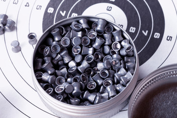 A box of lead shot for shotguns on top of cardboard targets