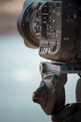 Camera and tripod shooting the sea and the beautiful coast of Sardinia, in Italy.