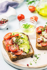 Avocado tomatoes goat cheese sandwiches. Selective focus, space for text.