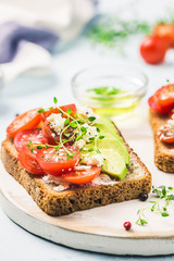 Avocado tomatoes goat cheese sandwiches. Selective focus, space for text.