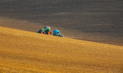 Obraz premium autumnal sowing in the field with modern mechanisms