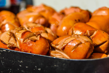 Heap of the fried sausages in steel tray