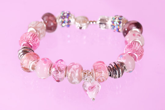 Pretty pink bracelet against pink background