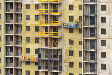 Fototapeta na wymiar Facade work and insulation of a multistory building