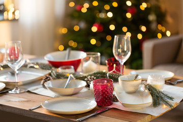 christmas, holidays and eating concept - table setting for festive dinner at home