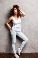 Fototapeta premium Full body portrait of happy smiling beautiful young woman, isolated over gray background.