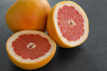 Fototapeta na wymiar food, fruits and healthy eating concept - close up of fresh juicy grapefruits
