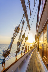 Fototapeta na wymiar Sunset at the Sailboat deck while cruising