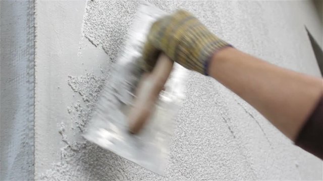 Application Of Facade Plaster,Worker Plastering The Facade Of The Building, Close-Up