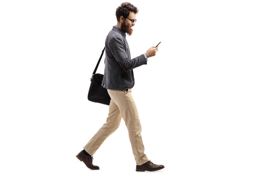 Man walking and looking into a mobile phone