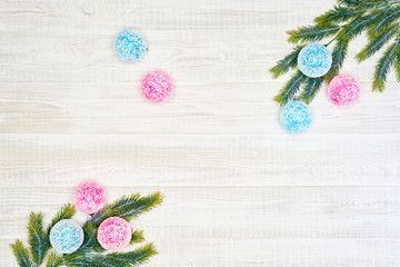 Festive composition of Christmas decorations on white wooden background.