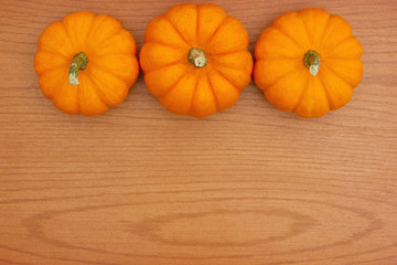 Autumn background with a pumpkins on wood