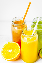 Fresh detox juices in glass bottles on white background
