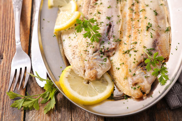 fried fish with lemon and parsley