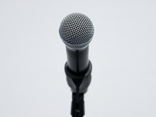 Shiny microphone close up on white background
