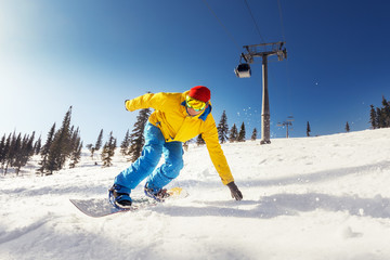 Fast and bright snowboarder at ski slope