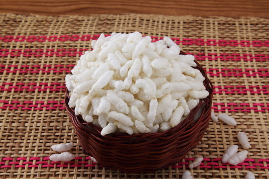 uncooked puffed rice in basket for indian gujarati traditional breakfast snack mamra