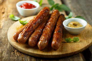 Homemade fried sausages with sauces
