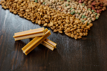 Dry pet food on black wooden table.