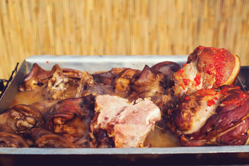 Food street. Pork knees on a tray outdoors. Czech market in Prague. Festival of street food.
