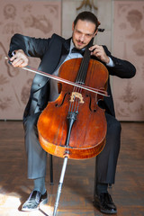 Young man playing the cello. Portrait of the cellist © biggur