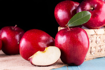 Red apples with leaves on the table