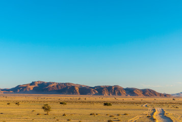 Gravel road to a spectacular mountain in Aus, Namibia.