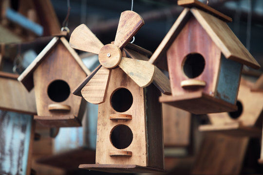 close up of hanging small wooden bird house