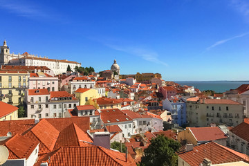 Fototapeta premium Top view of the red tiled roofs of Lisbon