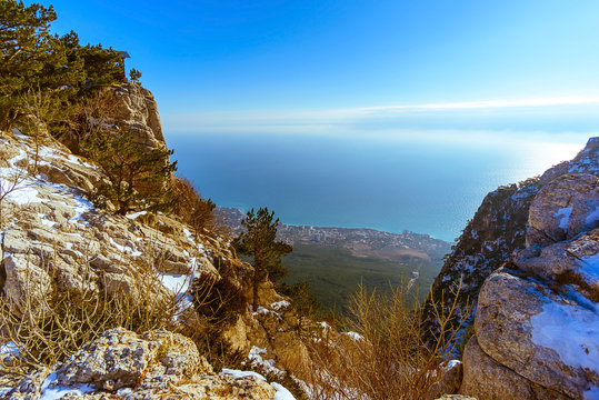 Sea through the gorge of mountains with a frosty sunny day, Ai-Petri mountain, Crimea, Russia