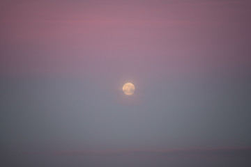 Bright moon in dawn on sea