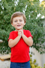 Fototapeta premium Happy child with red t-shirt in the garden