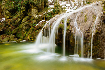 Waterfall Jur-Jur in winter, green moss and water, Crimea, Russia