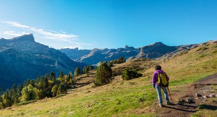 woman hiker walking in the Pyrenees mountains near the Pic Ossau