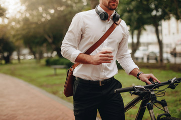 Man walking on street with his bicycle