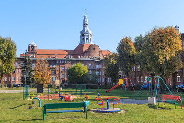 Historic Mining District of Nikiszowiec in Katowice in Polish Silesia. A playground for children located in the yard surrounded by tenement houses © stepmar
