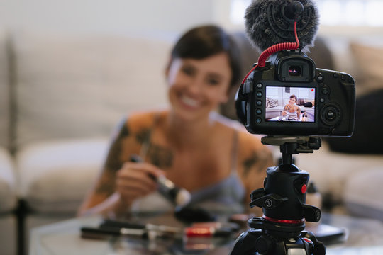 Woman making a video blog on cosmetics