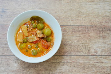 spicy boiled roasted duck meat with pineapple and eggplant in coconut milk curry on bowl