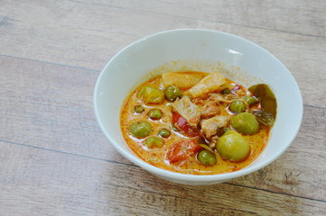 spicy boiled roasted duck meat with pineapple and eggplant in coconut milk curry on bowl